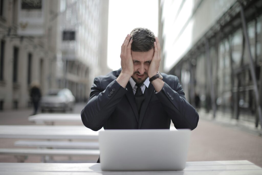 Stressed man holding his hands