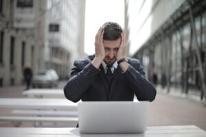 Stressed man holding his hands