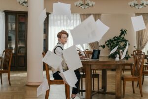 Stressed student throwing papers